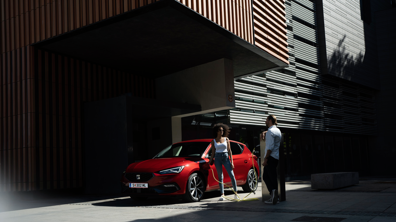 zwei Menschen neben dem Auto beim Laden 